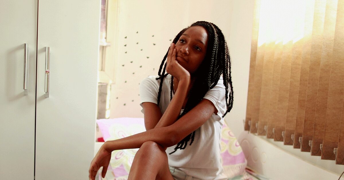 Young woman thoughtfully learning about her menstrual cycle and reproductive health